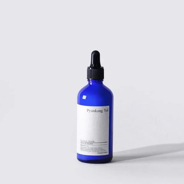 Blue bottle with black cap on a white background